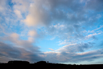 Blue sky background with gray clouds