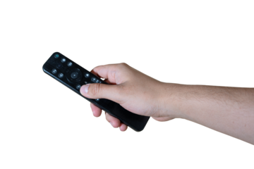 Human hand holding a black tv remote control against a transparent background pressing a button to change the channel. 
