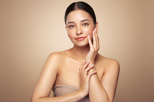 Portrait beautiful young woman with clean fresh skin. Model with healthy skin looks at an empty space, close up portrait. Cosmetology, beauty and spa