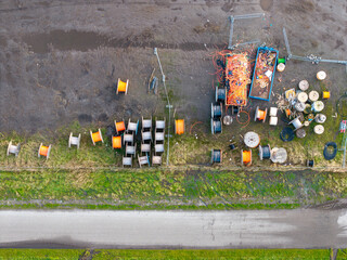 Top down aerial of rolls of fiber optic internet cable and conduit pipe for construction
