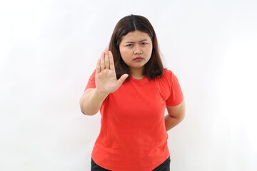Portrait of asian woman extending one hand, stop taboo sign, rejecting, declining something,...