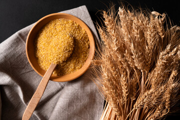 Ears of wheat close-up against the background of bulgur