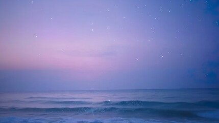 Obraz premium Starry Ocean at Twilight: Gentle waves under a purple-pink gradient sky adorned with subtle stars.