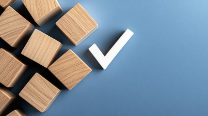 Wooden cubes featuring checkmarks are arranged on a flat blue surface, allowing ample space for additional text or information