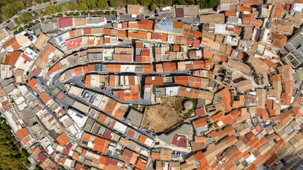 Fototapeta premium Aerial perpendicular view of the town of Rotondella located on a hill in Basilicata, Italy. 