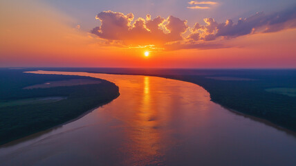 Fototapeta premium Aerial view of winding river at sunset, showcasing vibrant colors and reflections on water. serene landscape evokes sense of tranquility and natural beauty