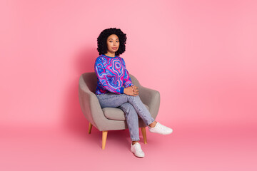 Photo of lovely adorable serious woman wear trendy clothes sit armchair isolated on pink color...