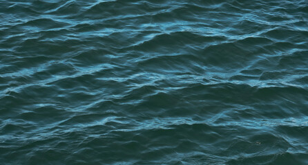 Banner blurred water surface, deep green color natural background, ocean 