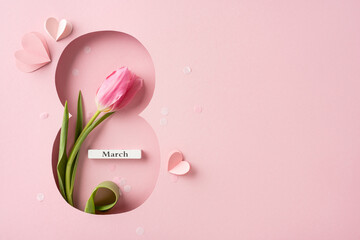 A pink tulip inside an elegant ribbon-shaped cutout, representing Women's Day and the month of...