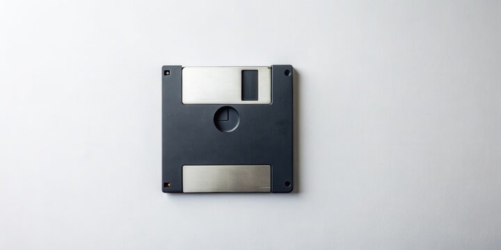 A single obsolete data storage disk sits on a plain surface