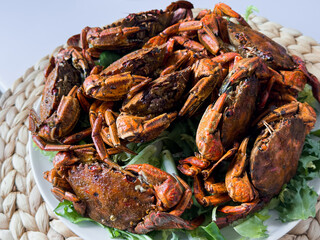 Deliciously spiced boiled crabs on leafy lettuce platter