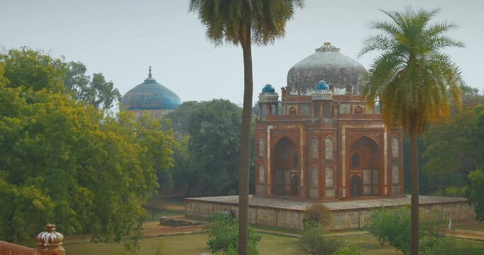 New Delhi, Delhi, India. Doves birds flying above Babur's Tomb near The Humayun's tomb. Famous place is Tomb of Mughal emperor, Mirza Nasir al-Din Muhammad commonly known as Humayun situated in Delhi