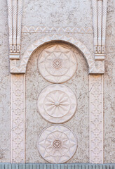 detailed close-up of architectural facade with geometric  carvings in traditional design arch, round circle forms, pale creamy background, uzbek style