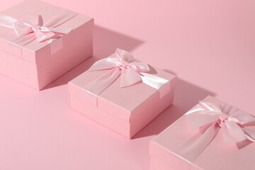Obraz premium Three beautiful wedding gifts on pink background