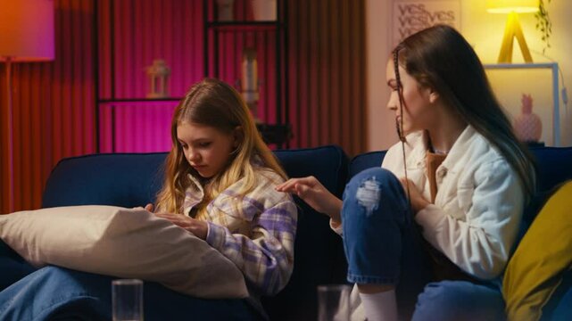 Sad teen girls make a pinky promise not to fight again and hug with relief