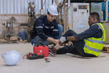 First aid support accident at work of worker at factory. Male worker has an accident on the floor...