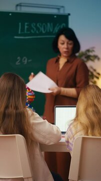 Strict math teacher reprimands schoolgirls during a lesson for misbehavior