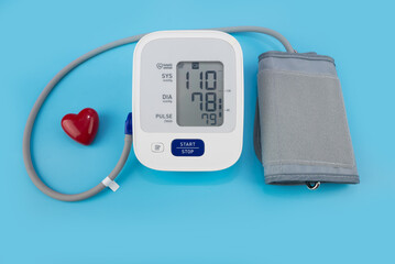 Red toy heart and tonometer on blue background. Healthcare concept. Cardiology - Heart care
