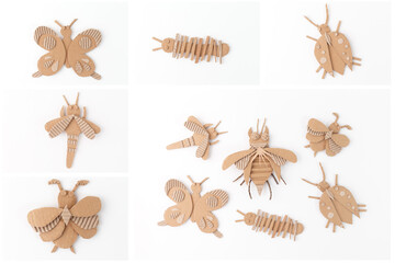 Handmade cardboard insect crafts arranged on white background. DIY eco-friendly bug figures including bee, butterfly, beetle, caterpillar, and moth. Creative recycling and upcycling art project,