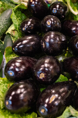 stand at a farmers market with bright purple eggplants