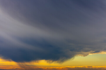Cloudy sky. Dramatic clouds illuminated by the sun