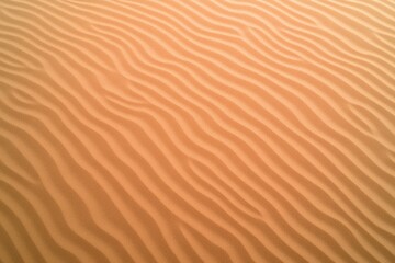 top-down view of fine desert sand with soft rippled texture natural daylight
