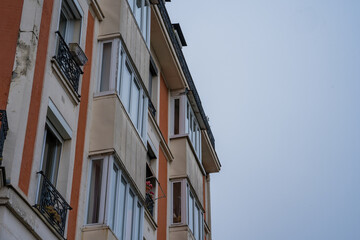 Charming building facade with detailed balconies under a cloudy sky