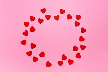 red hearts on a pink background like frame . Flat lay composition with copy space, perfect for Valentine's Day, love, wedding, or romantic greeting cards
