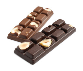 Tasty chocolate bars with nuts isolated on white