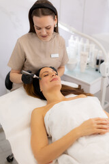 Fototapeta premium Microneedling session enhancing skin rejuvenation in a tranquil beauty clinic environment