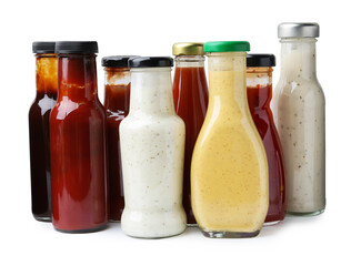 Different delicious sauces in glass bottles isolated on white