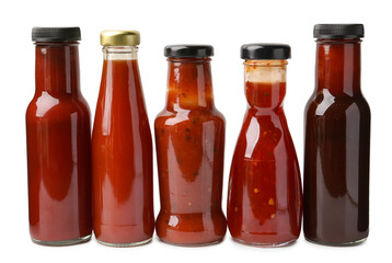 Different delicious sauces in glass bottles isolated on white