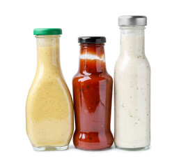 Different delicious sauces in glass bottles isolated on white