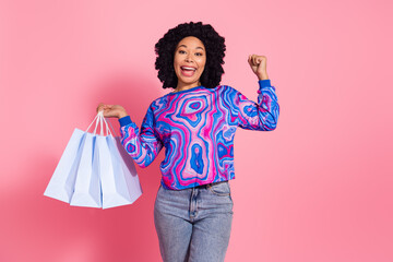 Photo of cheerful positive woman wear trendy sweatshirt hold packages sale offer isolated on pink...