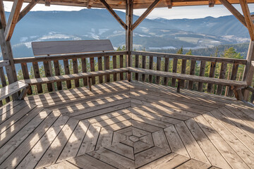 Hexagonal wooden building in the forest.