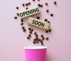 Opening soon symbol. Concept word Opening soon on wooden blocks. Beautiful pink background. Business and Opening soon concept. Copy space