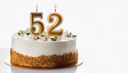 Decorated white cake for birthday or anniversary party, candle number 52, white background