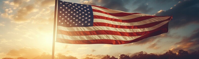 The American flag waves proudly against a backdrop of a stunning sunset, filling the sky with warm hues while illuminating the surrounding landscape.