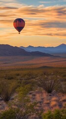 Obraz premium A vibrant hot air balloon floats gracefully against a stunning sunset sky. The serene desert landscape offers a perfect backdrop for adventure and tranquility. Generative AI.