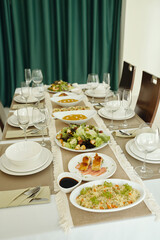 Dining table serving with beautiful plates with delicious meal in the restaurant