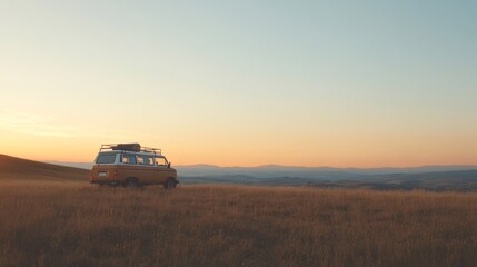 Vintage camper van parked in a field at sunset.