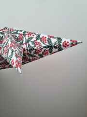 Christmas paper star with a festive pattern. Festive background against the ceiling. Abstract background with a December holiday motive.