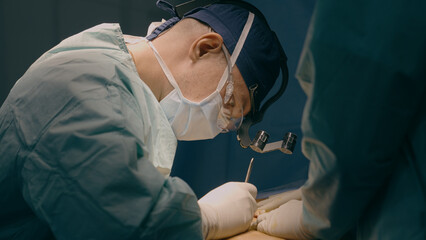 Doctor man in uniform physician surgeon medic nurse performing surgical operation at hospital...