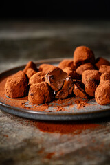 Tasty chocolate truffles powdered with cocoa on table.
Chocolate truffles image.
