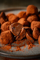 Tasty chocolate truffles powdered with cocoa on table.
Chocolate truffles image.
