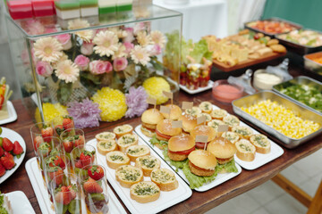 Setting up buffet table featuring various cuisines