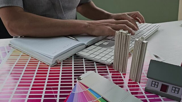 Designer working in graphic design Choose colors for working with computer at desk 