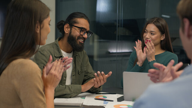 Business team multi ethnic women men group co-workers colleagues young creative managers sit at office conference table share ideas discuss startup project corporate brainstorm negotiate at workplace
