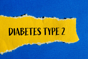 Diabetes type 2 message written on ripped torn yellow paper piece with blue background. Conceptual...