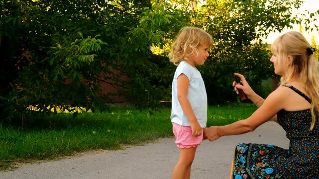 Mother sprays mosquito repellent on her child. Selective focus.